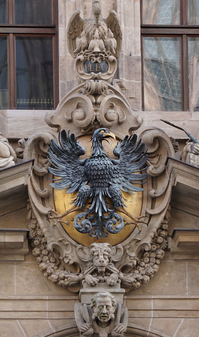 Central portal Cartouche with imperial eagle, above: Pelican brings his children back to life with his blood